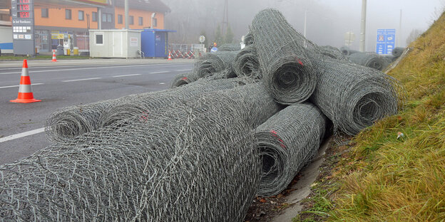Rollen von Drahtzäunen liegen neben einer Straße Rollen von Drahtzäunen liegen neben einer Straße