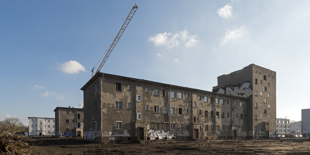 Ein Kran über einem verfallenem Gebäude