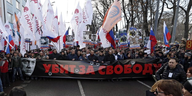 Viele Menschen auf einer STraße mit Russland-Fahnen und einem großen Transparent, auf dem der vor einem Jahr ermordete Kreml-kritiker Boris Nemzow zu sehen ist Viele Menschen auf einer STraße mit Russland-Fahnen und einem großen Transparent, auf dem der vor einem Jahr ermordete Kreml-kritiker Boris Nemzow zu sehen ist