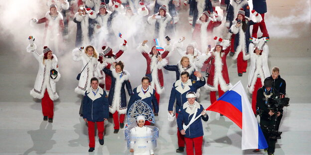 Frauen und Männer in Pelzmänteln, einer trägt eine russische Fahne Frauen und Männer in Pelzmänteln, einer trägt eine russische Fahne