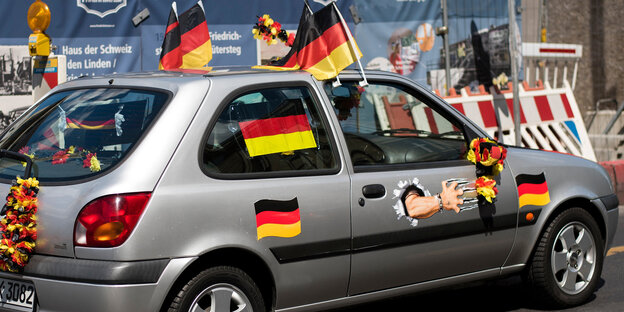 Ein Auto mit vielen Deutschland-Fahnen und -Aufklebern Ein Auto mit vielen Deutschland-Fahnen und -Aufklebern