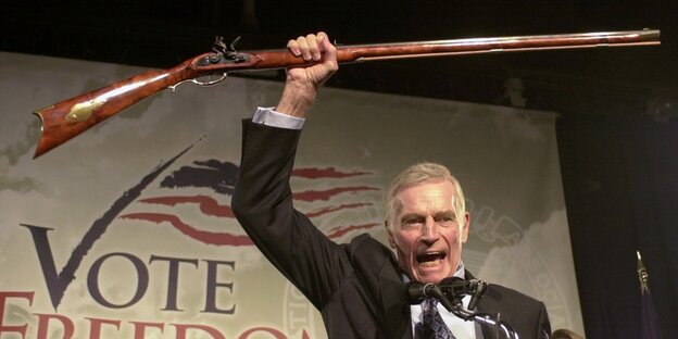 Charlton Heston mit einem Gewehr