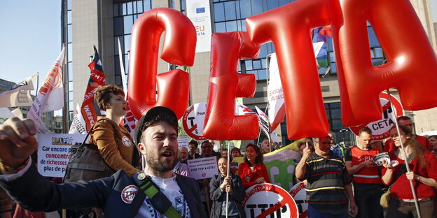 Menschen mit Plakaten und Luftballons demonstrieren gegen Ceta Menschen mit Plakaten und Luftballons demonstrieren gegen Ceta