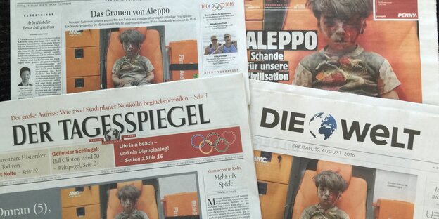 Die Titelseiten von mehreren Zeitungen, darunter der Tagesspiegel, Die Welt und die Berliner Zeitung, mit dem Bild des Jungen von Aleppo Die Titelseiten von mehreren Zeitungen, darunter der Tagesspiegel, Die Welt und die Berliner Zeitung, mit dem Bild des Jungen von Aleppo