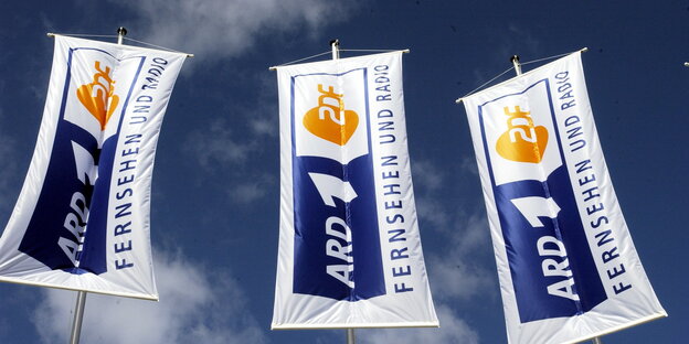 Werbefahnen von ARD und ZDF wehen vor blauem Himmel Werbefahnen von ARD und ZDF wehen vor blauem Himmel