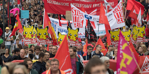Viele Menschen laufen mit Plakaten und Fahnen Viele Menschen laufen mit Plakaten und Fahnen