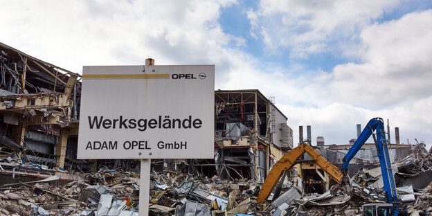 Vor einem Haufen Schrott steht ein Schild mit der Aufschrift „Werksgelände Adam Opel GmbH Vor einem Haufen Schrott steht ein Schild mit der Aufschrift „Werksgelände Adam Opel GmbH