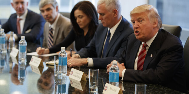 Trump mit drei Männern und einer Frau an einem Tisch sitzend Trump mit drei Männern und einer Frau an einem Tisch sitzend