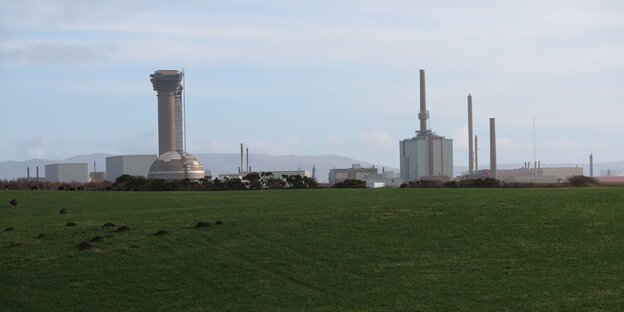 Umgebung von Sellafield: Eine grüne weite Wiese und eine Atommüllwiederaufbereitungs-Anlage Umgebung von Sellafield: Eine grüne weite Wiese und eine Atommüllwiederaufbereitungs-Anlage
