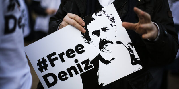 Jemand hält ein Plakat mit dem Gesicht von Deniz Yücel Jemand hält ein Plakat mit dem Gesicht von Deniz Yücel