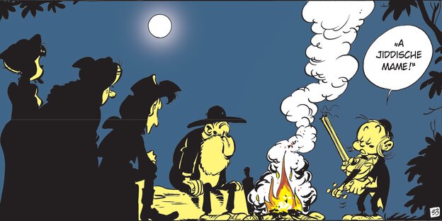 Lucky Luke und seine Begleiter sitzen am Lagerfeuer. Ein orthodox gekleideter Junge spielt auf seiner Geige ein jüdisches Lied.