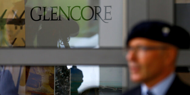 Ein Angestellter steht vor der Tür der Glencore Jahreshauptversammlung