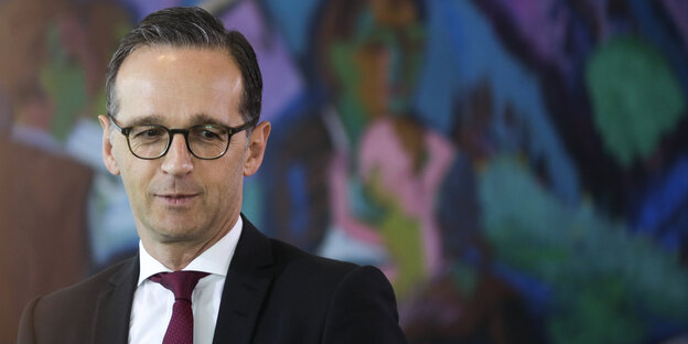 Justizminister Heiko Maas steht vor einer bemalten Wand Justizminister Heiko Maas steht vor einer bemalten Wand