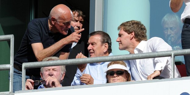 Martin Kind (stehend, links), Gerhard Schröder (sitzend, Mitte) auf der Tribüne