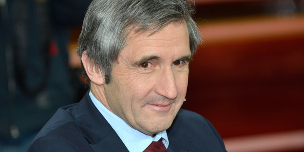 Ein Mann mit grauen Haaren und in Anzug und Krawatte Ein Mann mit grauen Haaren und in Anzug und Krawatte