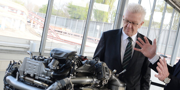 Winfried Kretschmann betrachtet einen Dieselmotor Winfried Kretschmann betrachtet einen Dieselmotor