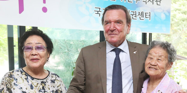 Gerhard Schröder zwischen zwei südkoreanischen Frauen Gerhard Schröder zwischen zwei südkoreanischen Frauen