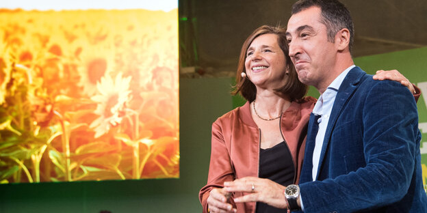 Katrin Göring-Eckardt und Cem Özdemir Arm in Arm auf einer Bühne Katrin Göring-Eckardt und Cem Özdemir Arm in Arm auf einer Bühne