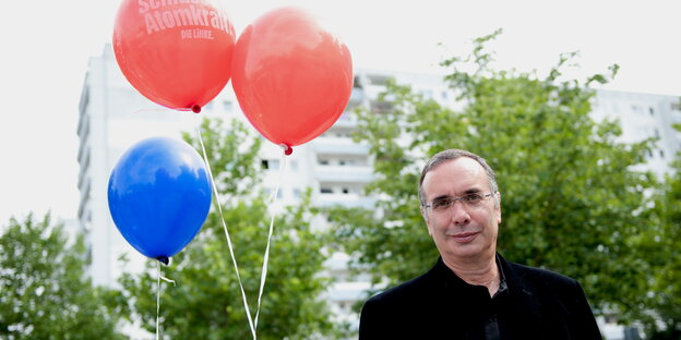 ein Mann und drei Luftballons, ein blauer und zwei rote ein Mann und drei Luftballons, ein blauer und zwei rote