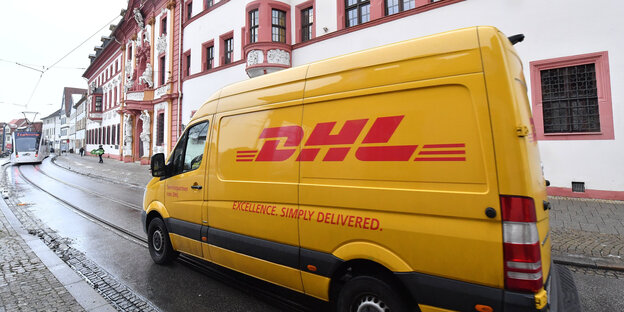 Ein Auslieferungswagen des Paketdienstes DHL fährt vorbei. Ein Auslieferungswagen des Paketdienstes DHL fährt vorbei.