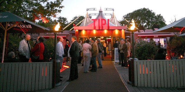 Eingang des Tipi am Kanzleramt, abends, mit mehreren Menschen davor Eingang des Tipi am Kanzleramt, abends, mit mehreren Menschen davor