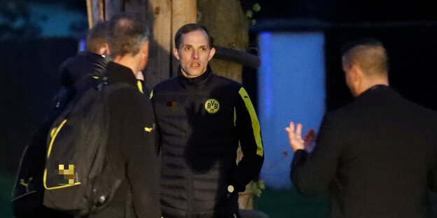 Der frühere BVB-Trainer Thomas Tuchel und Sicherheitsleute stehen nach dem Anschlag ratlos vor dem Bus von Borussia Dortmund Der frühere BVB-Trainer Thomas Tuchel und Sicherheitsleute stehen nach dem Anschlag ratlos vor dem Bus von Borussia Dortmund
