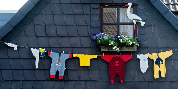Babystrampler vor einer Hauswand Babystrampler vor einer Hauswand