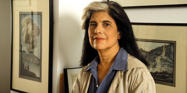 Susan Sontag steht vor gerahmten Bildern Susan Sontag steht vor gerahmten Bildern