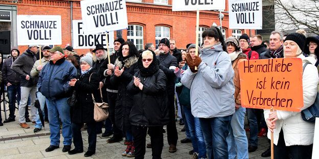 Kundgebungsteilnehmer mit Plakaten auf denen „Schnauze voll!“ steht Kundgebungsteilnehmer mit Plakaten auf denen „Schnauze voll!“ steht