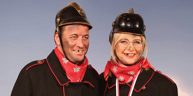 Ulrike Scharf und ein Begleiter verkleidet als Feuerwehsleute Ulrike Scharf und ein Begleiter verkleidet als Feuerwehsleute