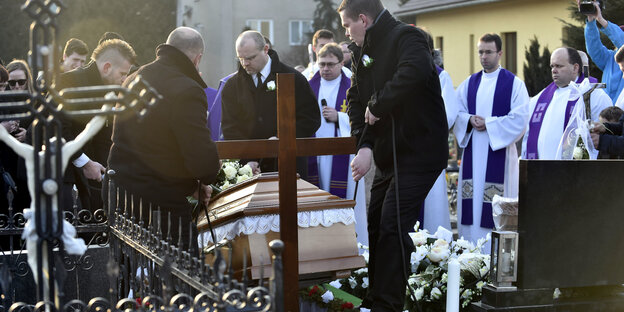 Der Sarg des toten Enthüllungsjournalisten Jan Kuciak wird in das Grab hinabgelassen bei der Kirche des Heiligen Franz von Assisi Der Sarg des toten Enthüllungsjournalisten Jan Kuciak wird in das Grab hinabgelassen bei der Kirche des Heiligen Franz von Assisi