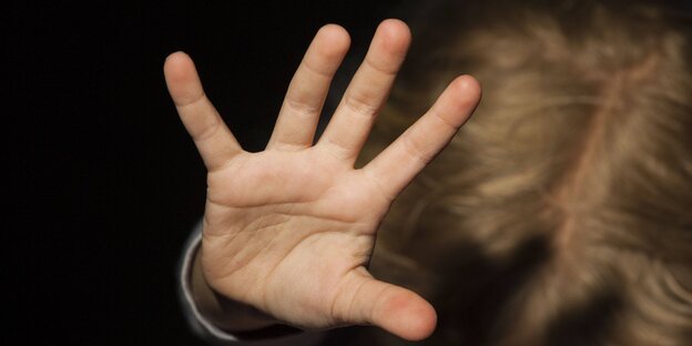 Eine Kinderhand streckt sich dem Betrachter abwehrend entgegen Eine Kinderhand streckt sich dem Betrachter abwehrend entgegen