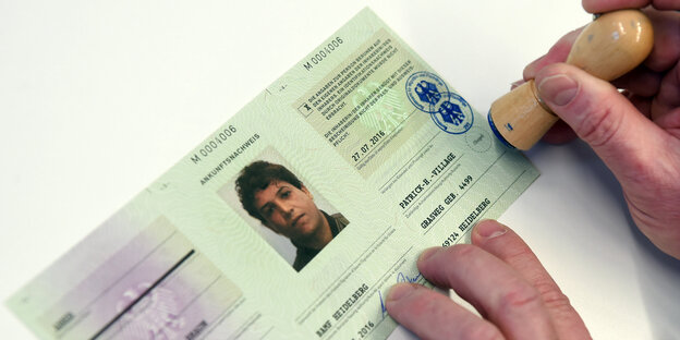 Ein Flüchtlingsausweis wird abgestempelt Ein Flüchtlingsausweis wird abgestempelt