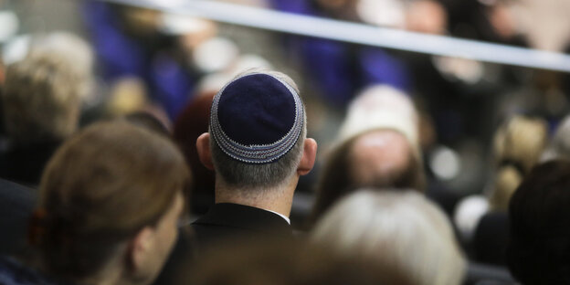 Man sieht einen Mann von hinten, er trägt eine Kippa Man sieht einen Mann von hinten, er trägt eine Kippa