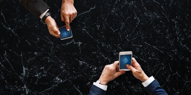 Zwei Personen tippen auf der Tatstatur ihrer jeweiligen Smartphones Zwei Personen tippen auf der Tatstatur ihrer jeweiligen Smartphones
