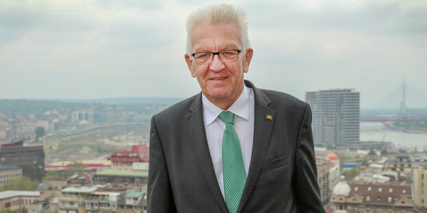 WInfried Kretschmann lächelt, im Hintergrund die Stadt WInfried Kretschmann lächelt, im Hintergrund die Stadt