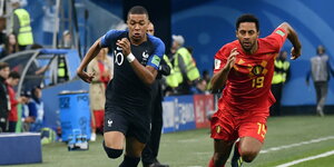 zwei Fußballer rennen nach dem Ball zwei Fußballer rennen nach dem Ball