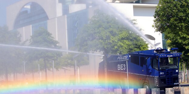 Ein Wasserwerfer der Polizei bewässert das Grün am Bundeskanzleramt in Berlin Ein Wasserwerfer der Polizei bewässert das Grün am Bundeskanzleramt in Berlin