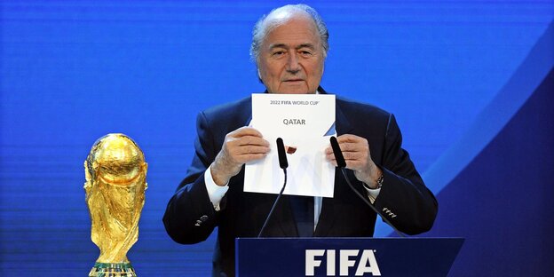 Joseph Blatter, damals FIFA Präsident, hält einen Zettel mit der Aufschrift «Katar» während der Bekanntgabe des Ausrichters der Fußball-WM 2022 Joseph Blatter, damals FIFA Präsident, hält einen Zettel mit der Aufschrift «Katar» während der Bekanntgabe des Ausrichters der Fußball-WM 2022