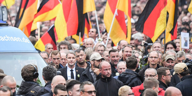 Björn Höcke inmitten einer Menschenmenge, im Hintergrund viele Deutschlandflaggen Björn Höcke inmitten einer Menschenmenge, im Hintergrund viele Deutschlandflaggen