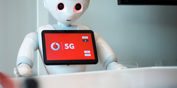 Roboter mit "5G" auf Bildschirm Roboter mit "5G" auf Bildschirm