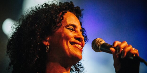 Neneh Cherry hält ein Mikrofon Neneh Cherry hält ein Mikrofon