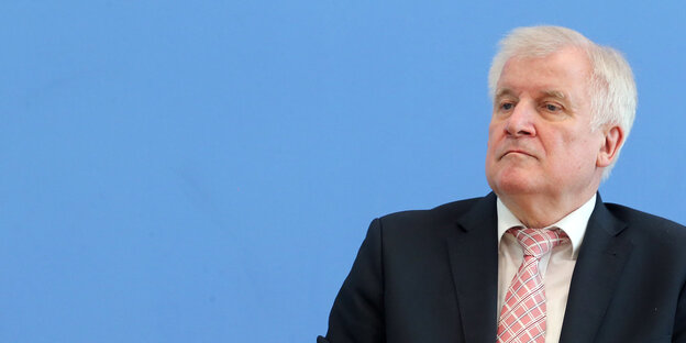 Horst Seehofer mit Anzug und Krawatte vor hellblauem Hintergrund Horst Seehofer mit Anzug und Krawatte vor hellblauem Hintergrund