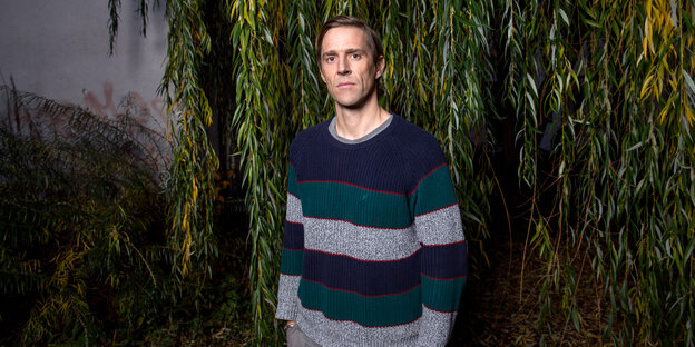 Matias Faldbakken, ein Mann in einem blau-grau-gestreiften Pulli, steht vor einer Trauerweide Matias Faldbakken, ein Mann in einem blau-grau-gestreiften Pulli, steht vor einer Trauerweide
