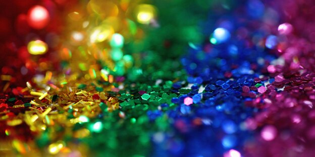 Viele Glitzerpartikel in den Farben des Regenbogens Viele Glitzerpartikel in den Farben des Regenbogens
