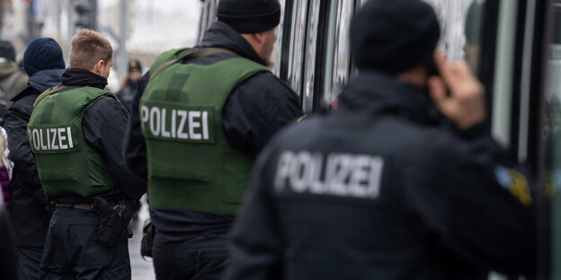 Polizisten vor einem Zug Polizisten vor einem Zug