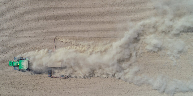 Staub hinter einem landwirtschaftlichen Fahrzeug Staub hinter einem landwirtschaftlichen Fahrzeug