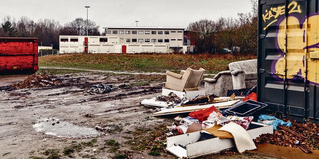 Müll liegt auf einer Brache, dahinter sind die Wohncontainer in der Luruper Hauptstraße. Müll liegt auf einer Brache, dahinter sind die Wohncontainer in der Luruper Hauptstraße.
