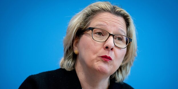 eine Frau vor blauem Hintergrund eine Frau vor blauem Hintergrund