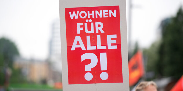 Eine Frau trägt ein Schild mit der Aufschrift "Wohnen fuer alle?!" Eine Frau trägt ein Schild mit der Aufschrift "Wohnen fuer alle?!"